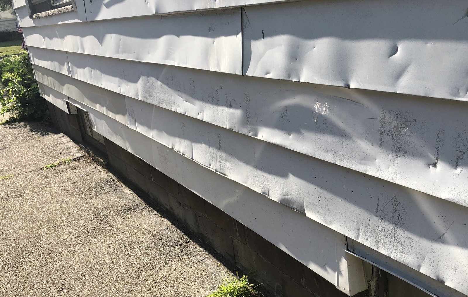 Hail dents across aluminium siding